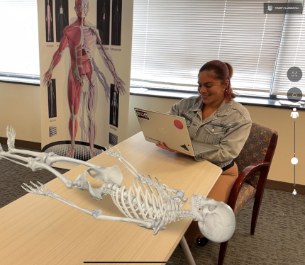 Student using augmented reality anatomy tool with a virtual skeleton