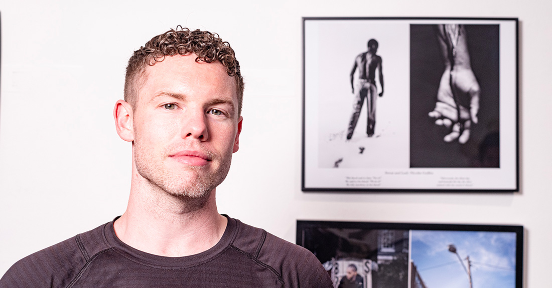 Man in front of his art work