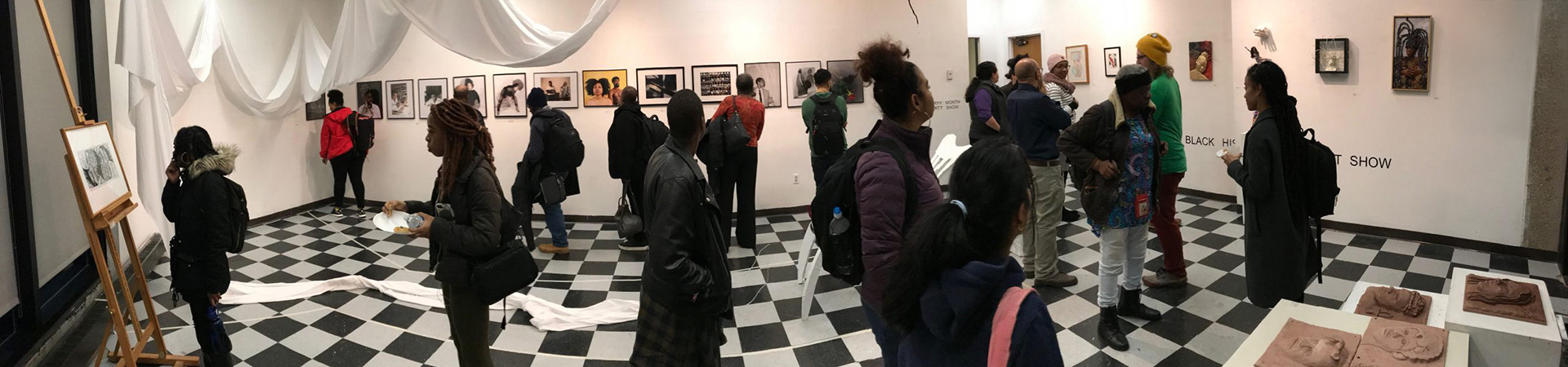 People looking at art in UDC art gallery