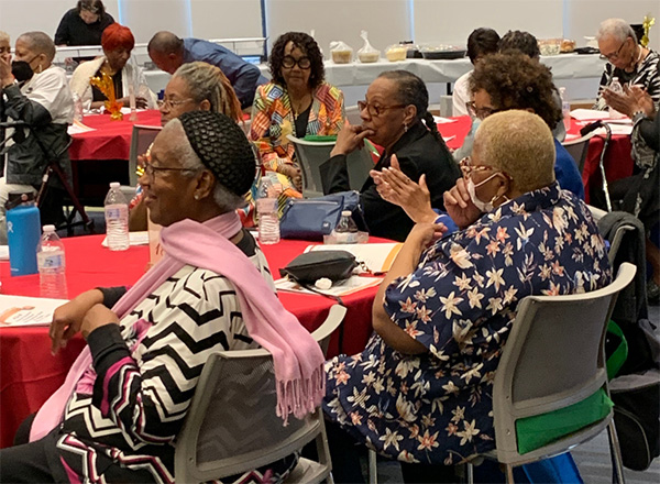 Elderly people sitting at an event