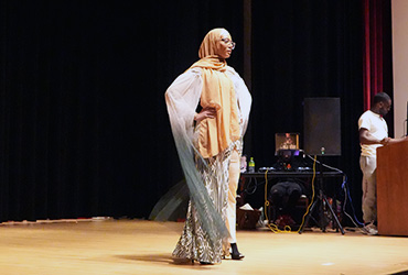 Young woman wearing a hijab in a fashion show.