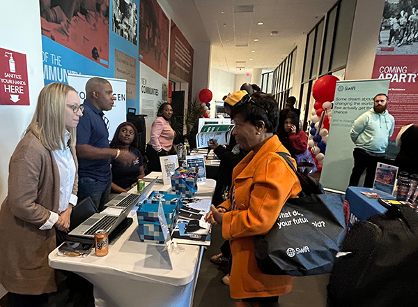 People talking with potential employeers at a career fair