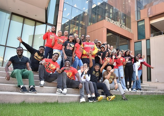 Students and President Edington on the steps outside the UDC student center