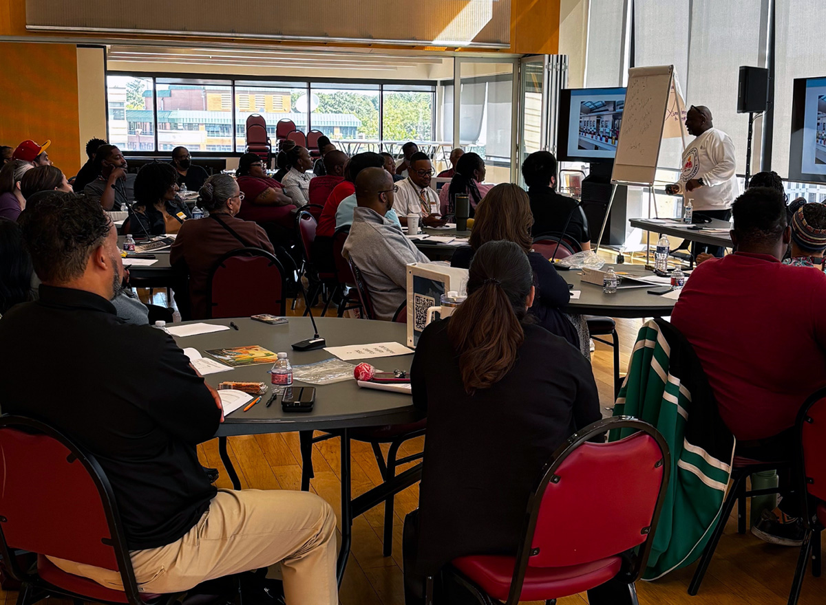 A group of people in a conference room attending a UDC training.