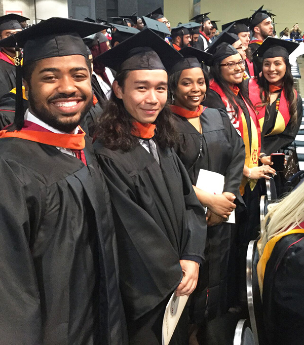 students at graduations in cap and gowns 