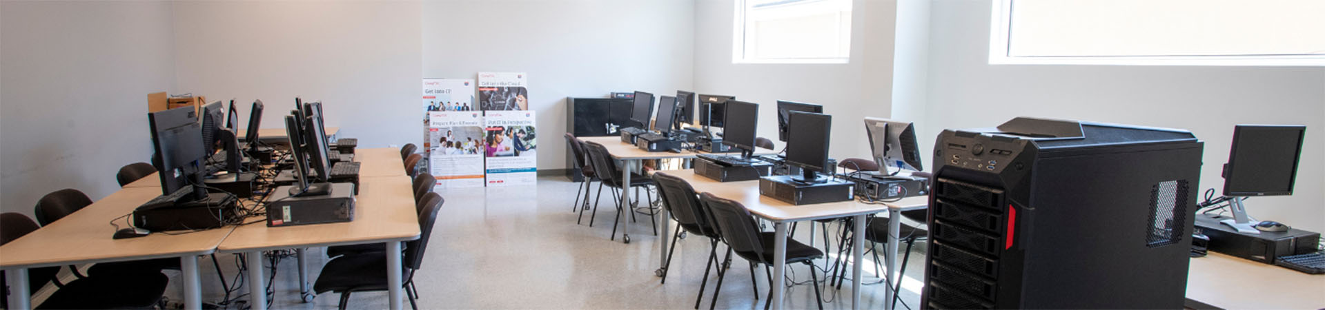 Empty classroom with tables, chairs and computers